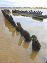 Hulk of wooden sailing ship on beach