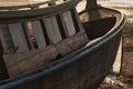 Hull and deckhouse of a wooden boat lying on the shore due to low tide, close-up