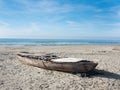 Hull of a shipwrecked small sailboat on the beach