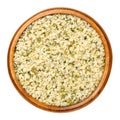 Hulled hemp seeds in wooden bowl over white