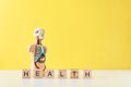 Human anatomy mannequin with internal organs and word HEALTH on a yellow background. Medical health concept