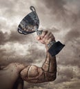 Human arm prosthesis with winner cup. Royalty Free Stock Photo