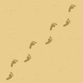 Human barefoot footprint path on yellow sand background. Royalty Free Stock Photo