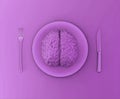 Human brain on a plate with a fork and a knife