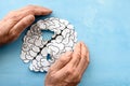 Human brain made of paper on a blue background a thrifty hand protects the human brain. Royalty Free Stock Photo