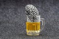 Human brain in a miniature beer mug Royalty Free Stock Photo