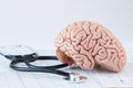 Human brain model and a black stethoscope on background of brain waves Royalty Free Stock Photo
