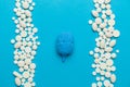 Human brain and pills on blue background. Neurological diseases and surgical treatment. Intelligence and psychological therapy