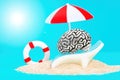 Human brain relaxing under a sun umbrella on a sandy beach Royalty Free Stock Photo