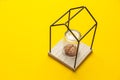 Human brain under glass flask isolated in house on yellow background. Self-closure, stress and depression. lack of communication