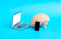 Human brain using smartphone and laptop