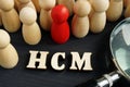 Human capital management HCM. Figurines and magnifying glass Royalty Free Stock Photo