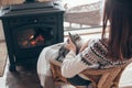 Human with cat relaxing by the fire place Royalty Free Stock Photo