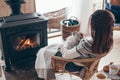 Human with cat relaxing by the fire place Royalty Free Stock Photo