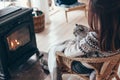 Human with cat relaxing by the fire place Royalty Free Stock Photo