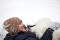 A human and a dog are best friends. Man and dog walk in snowy forest in winter in deep snow on a sunny day. Royalty Free Stock Photo