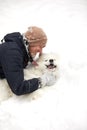 A human and a dog are best friends. Man and dog walk in snowy forest in winter in deep snow on a sunny day. Royalty Free Stock Photo