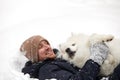 A human and a dog are best friends. Man and dog walk in snowy forest in winter in deep snow on a sunny day. Royalty Free Stock Photo