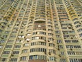 The facade of a huge residential building with many windows and balconies