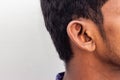 Human Ear - Close up of man ear Its body part helps to hearing sound waves. Face with a human ear and hair. Portrait of indian man Royalty Free Stock Photo