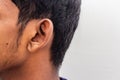 Human Ear - Close up of man ear Its body part helps to hearing sound waves. Face with a human ear and hair. Portrait of indian man Royalty Free Stock Photo