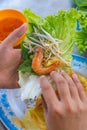 Human eating Vietnamese shrimp crepe with vegetables- Banh Xeo