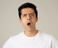 Human expressions and emotions. Young attractive man with a surprised face, eyes and mouth open