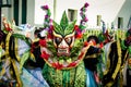 Human in extraordinary bright costume poses for photo on dominican carnival