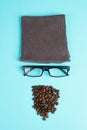 Human face made with a wool hat, glasses and coffee beans as a beard, funny minimalist portrait, eco freak lifestyle, having break