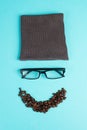 Human face made with a wool hat, glasses and coffee beans as a beard, funny minimalist portrait, eco freak lifestyle, having break