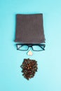Human face made with a wool hat, glasses and coffee beans as a beard, funny minimalist portrait, eco freak lifestyle
