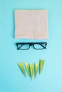 Human face of a man made with a wool hat, glasses and leaves as a beard, funny minimalist portrait, eco freak lifestyle