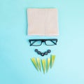 Human face of a man made with a wool hat, glasses and leaves as a beard, funny minimalist portrait, eco freak lifestyle, nerd