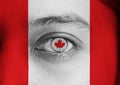 Human face painted Canada flag with the red maple leaf on the center of eye or eyeball Royalty Free Stock Photo