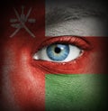 Human face painted with flag of Oman
