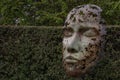 Human face statue in the botanical garden