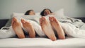 Human feet moving in bed in funny rhythm, couple having fun in bedroom