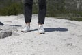 Human feet in shoes on a stone surface Royalty Free Stock Photo