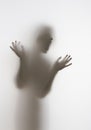 Scary diffuse human face and hands silhouette shouting behind a curtain Royalty Free Stock Photo