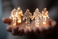 Human figures made of digital circuitry and glowing light particles floating above outstretched hands Royalty Free Stock Photo