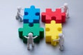 Human Figures Solving Jigsaw Puzzle Royalty Free Stock Photo