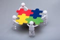 Human Figures Solving Jigsaw Puzzles Royalty Free Stock Photo