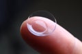 Human finger holding soft contact lens Royalty Free Stock Photo