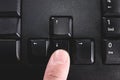 Human finger pressing the directional down key from a black keyboard Royalty Free Stock Photo