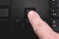 Human finger pressing the directional up key from a black keyboard Royalty Free Stock Photo