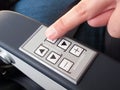 Human finger pressing push buttons on the armrest Royalty Free Stock Photo