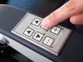 Human finger pressing push buttons on the armrest Royalty Free Stock Photo