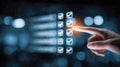 Human finger selecting or interacting with digital checklist interface on a blurred dark background, symbolizing task completion Royalty Free Stock Photo