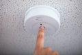 Human Finger Testing Smoke Detector Royalty Free Stock Photo