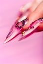 Human fingers with long fingernail over pink Royalty Free Stock Photo